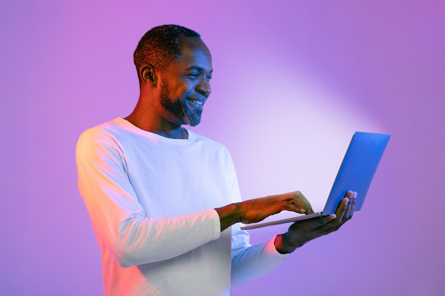 happy-african-american-man-using-laptop-and-smilin-2025-03-18-16-17-20-utc