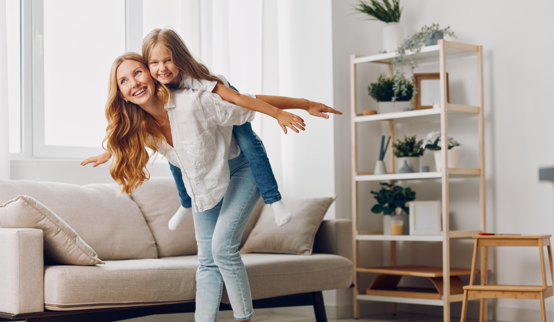 Image of a mother carrying her child on her back in an apartment